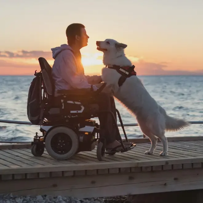 Occupational therapist adjusting a powered wheelchair during an assessment