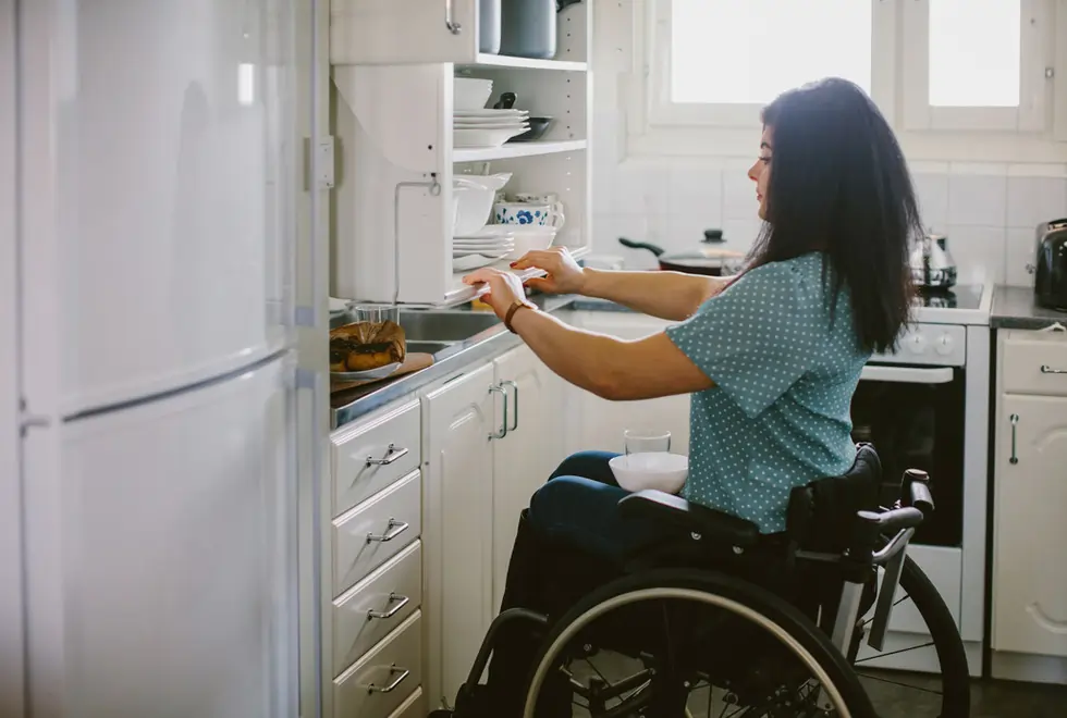Active wheelchair user in a kitchen at home