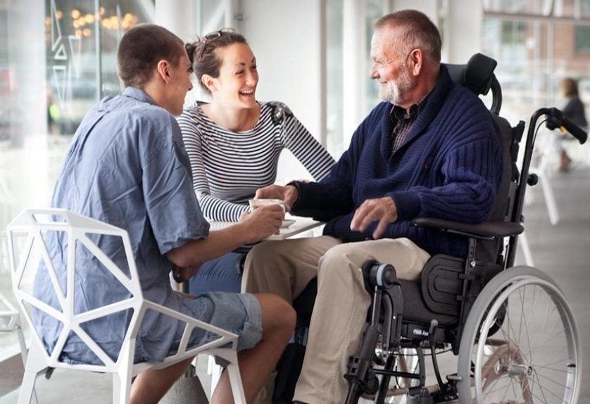 Older gentleman spending time with younger family members